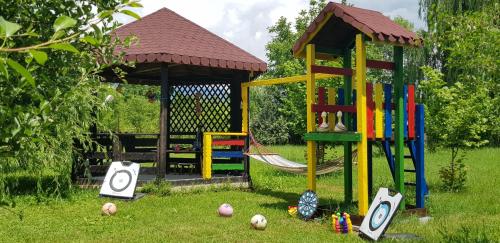a playground with a gazebo and a playset at Pensiunea Magnolia din Tismana in Tismana