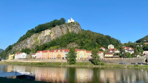 a town with a castle on top of a mountain at Berta's Apartments in Děčín