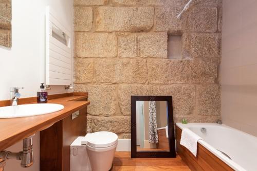 a bathroom with a tub and a toilet and a sink at ELDUAYEN in Vigo