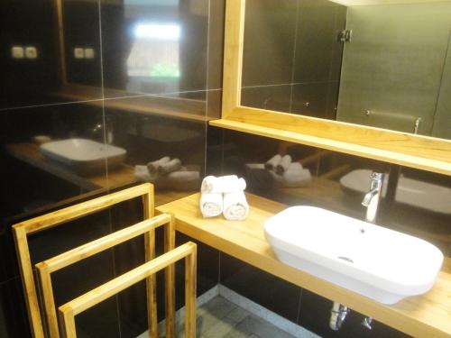a bathroom with a sink and a mirror at Jepara Marina Beach Bungalows in Jepara