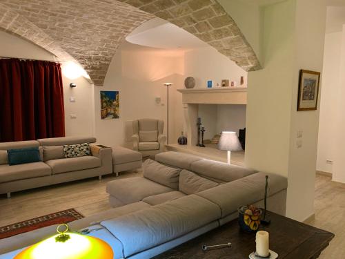 a living room with a couch and a living room with a fireplace at Il Casale Salcim in Torricella Peligna