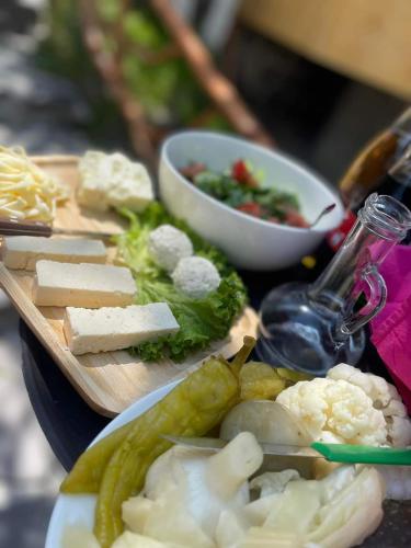 a plate of food with cheese and vegetables on a table at Village Jazz in Chimankend