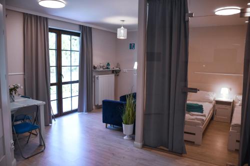 a living room with a bed and a table at Apartamenty Liliowa 3 in Dębki