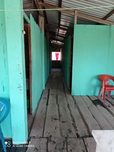 a hallway of an old building with a red bench at Barra Zacapulco - Palapa Abraham 