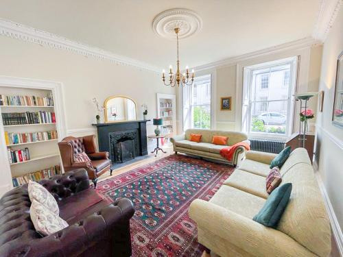 a living room with two couches and a fireplace at Remarkable 5BR Townhouse with Garden, Sleeps 12 in Edinburgh