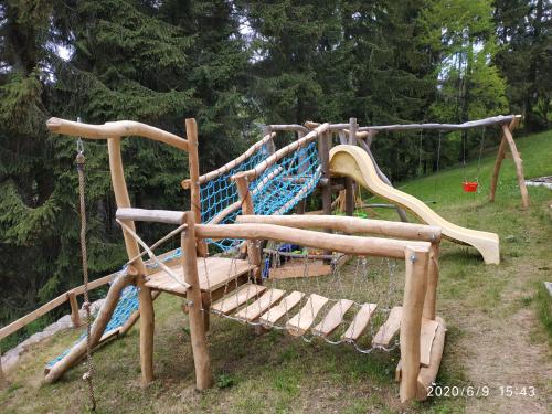 a playground with a swing set in a park at Penzion Eden in Pec pod Sněžkou