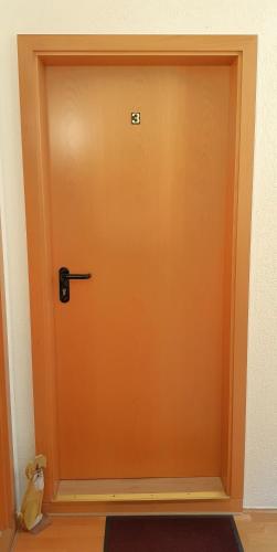 an orange door in a room with a dog at Villa Hoffnung in Bad Elster
