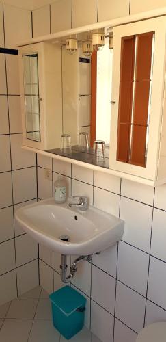 a bathroom with a white sink and a mirror at Villa Hoffnung in Bad Elster