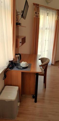 a desk in a room with a table and a chair at Villa Hoffnung in Bad Elster