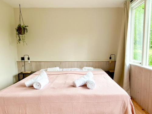 a bedroom with a bed with two towels on it at Idyllic house with 360 view of nature in Dalfsen