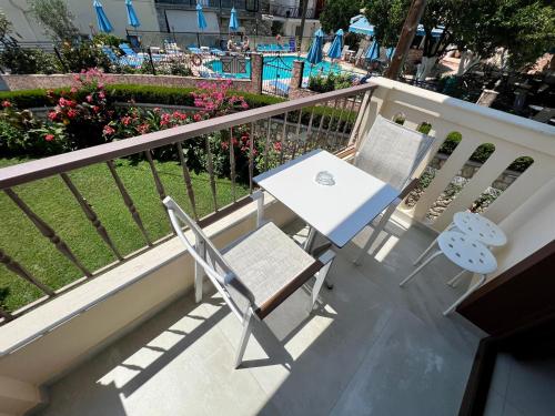 a table and two chairs sitting on a balcony at Valentinos House in Parga