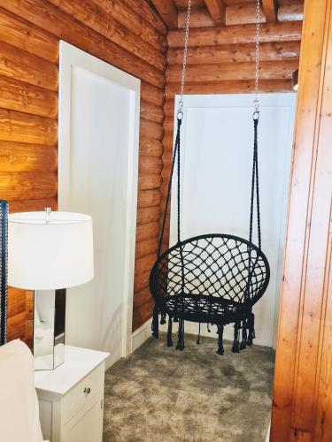 a swing in the corner of a room at Kaoglen Apollo-Hot tub-Cairngorms-Pet friendly in Balnald