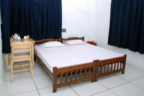 a bedroom with a large bed and a table at Jojies Homestay Fortkochi in Cochin