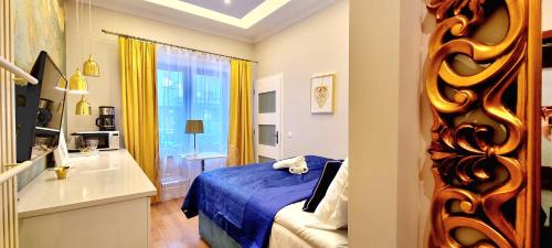 a bedroom with a blue bed and a window at VIP Apartamenty Stara Polana 2 in Zakopane