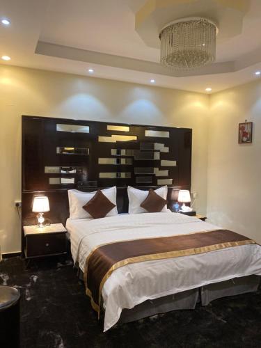 a bedroom with a large bed with a large headboard at ABHASKY in Abha