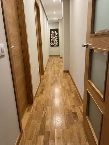 a hallway with a wooden floor and a door at AVA-2 in Arévalo