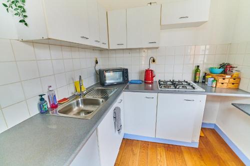 a small kitchen with a sink and a microwave at César in Brussels