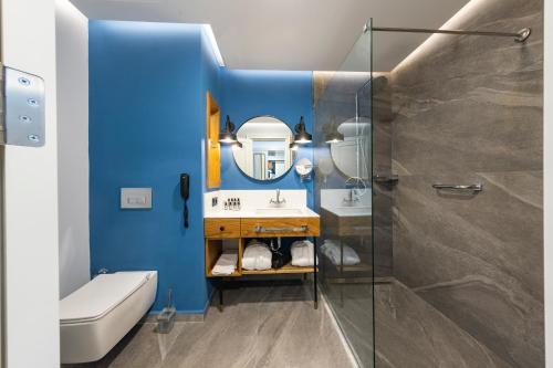 a bathroom with a sink and a shower at Soliport Hotel & SPA in Alaçatı