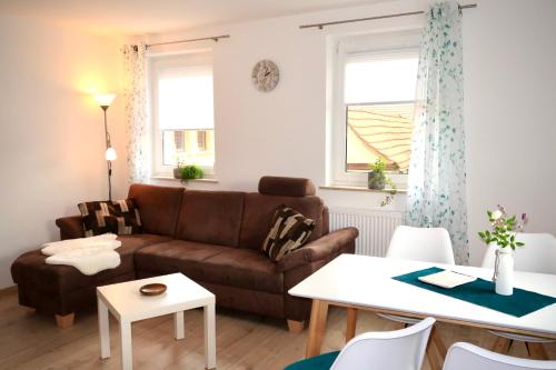 a living room with a couch and a table at Ferienwohnung Düsel in Maroldsweisach