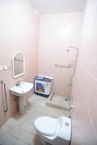 a bathroom with a toilet and a sink at Al Eairy Apartments - Al Ahsa -2 in Al Ahsa