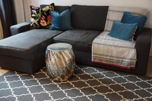 a living room with a couch and a table at Stunning pied-a-terre moments from the water. in Netley