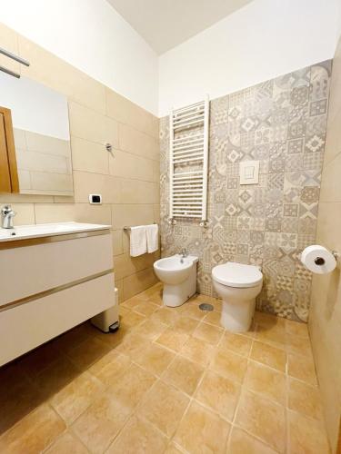 a bathroom with a toilet and a sink at Profumo di Limoni Vacation Rental in Procida