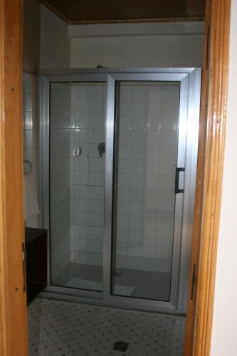 a bathroom with a shower with a glass door at Jerusalem Hotel Lalibela in Lalibela