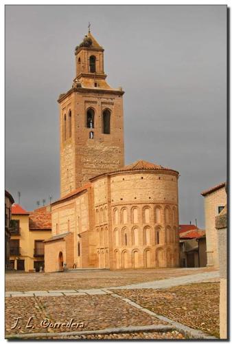 a large brick building with a clock tower on top at AVA-1 in Arévalo