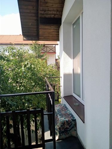 a small balcony with a bench next to a window at Family Apartments Dorobok in Lviv