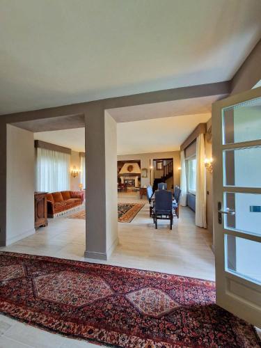 a large living room with a couch and a table at Villa Sarchi in Grantola