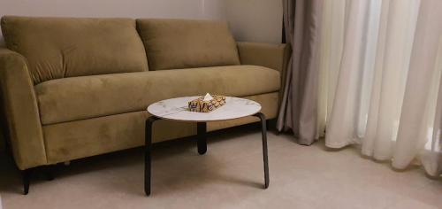 a table with a cake on it next to a couch at IBIRIS in Oran