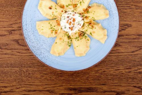 a plate of food with a flower on a table at Grand Hotel Kempinski High Tatras in Štrbské Pleso