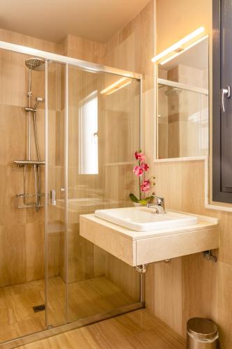 a bathroom with a sink and a glass shower at La Casa De Almocita in Dúrcal