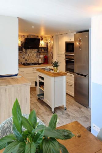 a kitchen with a island in the middle of a kitchen at La Bulle Bleue Futuroscope in Chasseneuil-du-Poitou