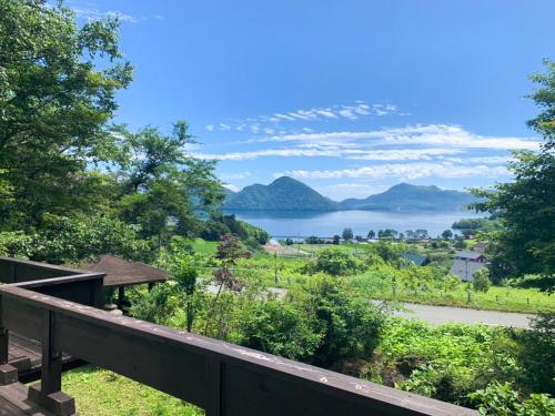 a view of a lake from a deck at The lakeview toya Shirokumanoyado in Lake Toya