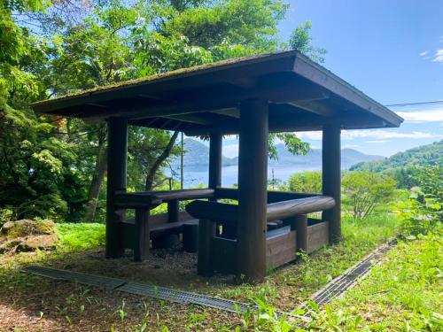 a shelter on the side of a hill at The lakeview toya Shirokumanoyado in Lake Toya