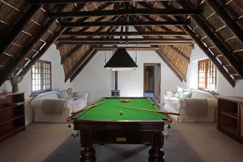 a living room with a pool table in it at Jardin de la Ferme in Franschhoek