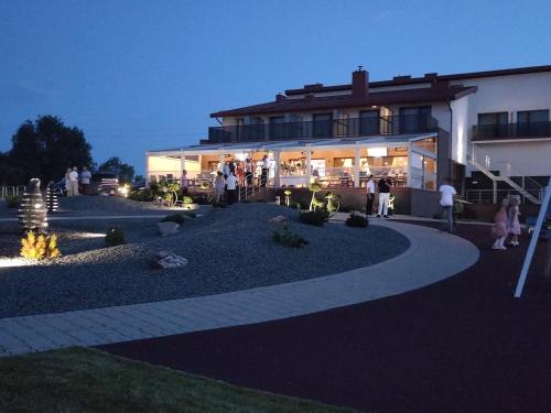 a group of people standing outside of a building at Motel Panorama in Šiauliai