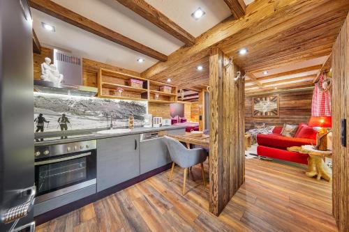 a kitchen with wooden walls and wooden flooring at Haus Magnushof in Eisenberg