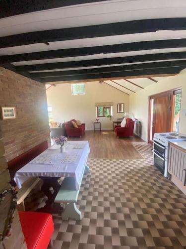 a living room with a table in the middle at CuckOO Nest Entire house in Annaghmore
