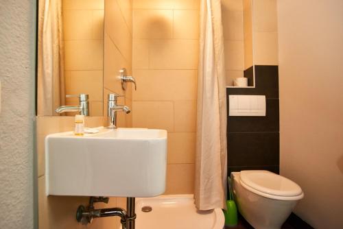 a small bathroom with a sink and a toilet at Hotel City Inn in Magdeburg
