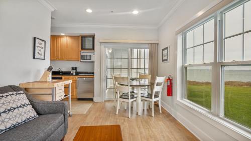 a living room with a couch and a table with chairs at The Cliffside Resort Condominiums in Greenport