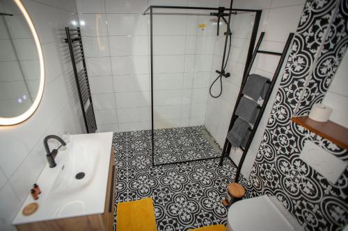 a bathroom with a shower and a tub and a sink at Bed & Breakfast Bakker Meijer in Heemskerk
