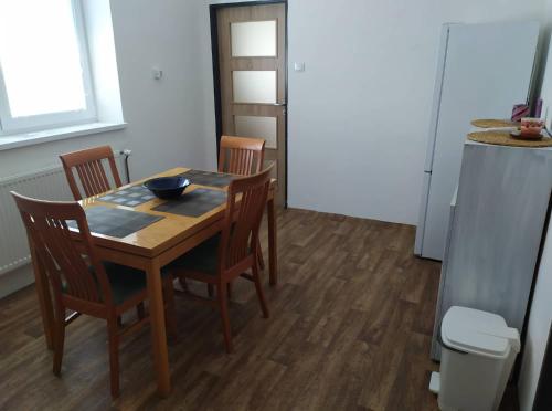 a dining room table with chairs and a bowl on it at Apartmán Olomouc Nemilany in Olomouc