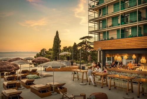 a rendering of a hotel patio with tables and chairs at PLACES Dalmacija by Valamar in Makarska