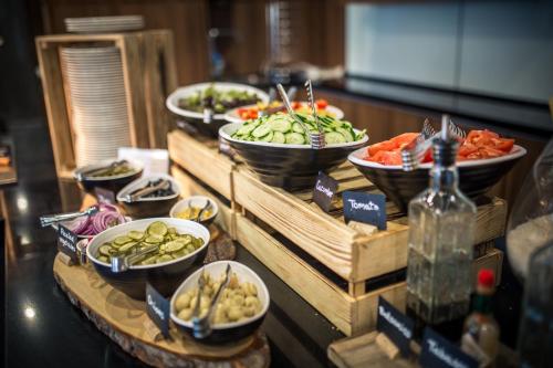 a buffet with plates of food on a table at Mercure Riga Centre in Rīga