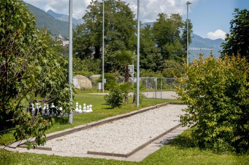 a park with white birds sitting on the grass at Parkhotel Emmaus - Casa del Sole in Ascona