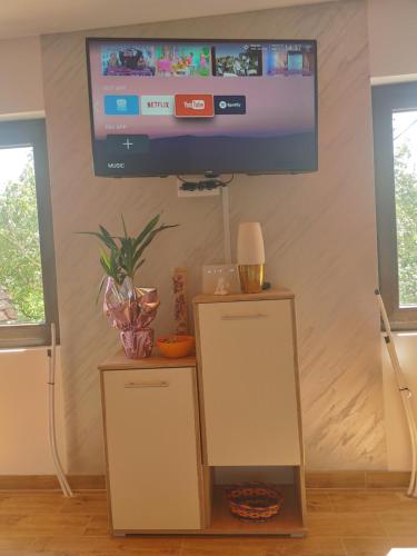 a flat screen tv hanging on a wall in a living room at Vila Bella Mia in Timotijevići