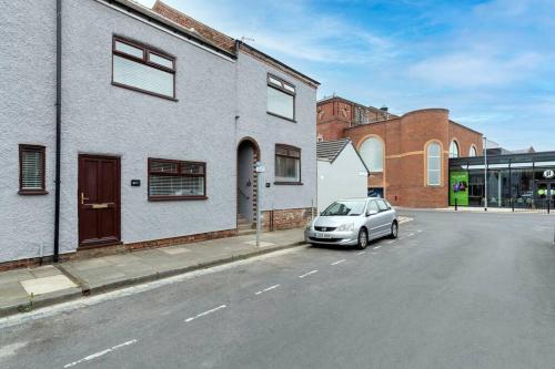a car parked on the side of a street at Modern centrally located 3 bed property with TVs in each bedroom super fast WiFi and crisp white hotel linen hosted by Our Home Short Stays in Darlington