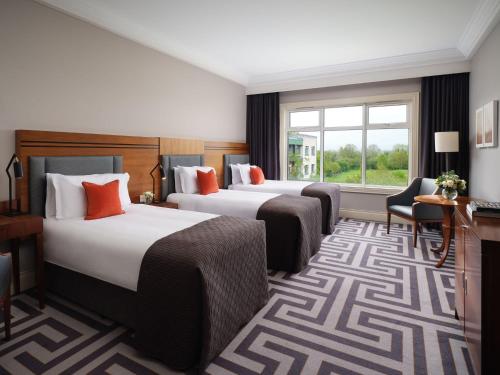 a hotel room with two beds and a window at Lyrath Estate in Kilkenny